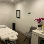 a white room with a bed and a desk