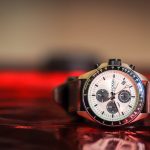 round black and white Fossil chronograph watch with brown leather band displaying at 10:42