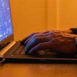a person using a laptop computer on a desk